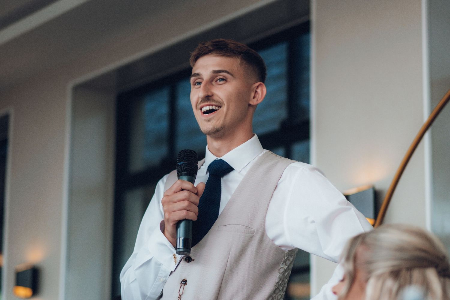 Wedding reception speeches and reactions captured at an elegant indoor venue.