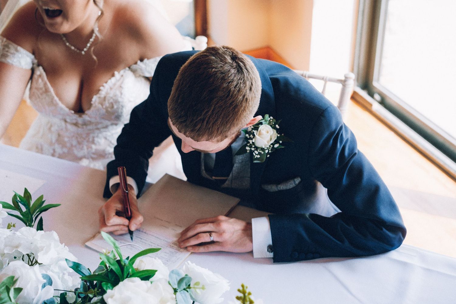Close-up details of wedding decor and floral arrangements on tables.