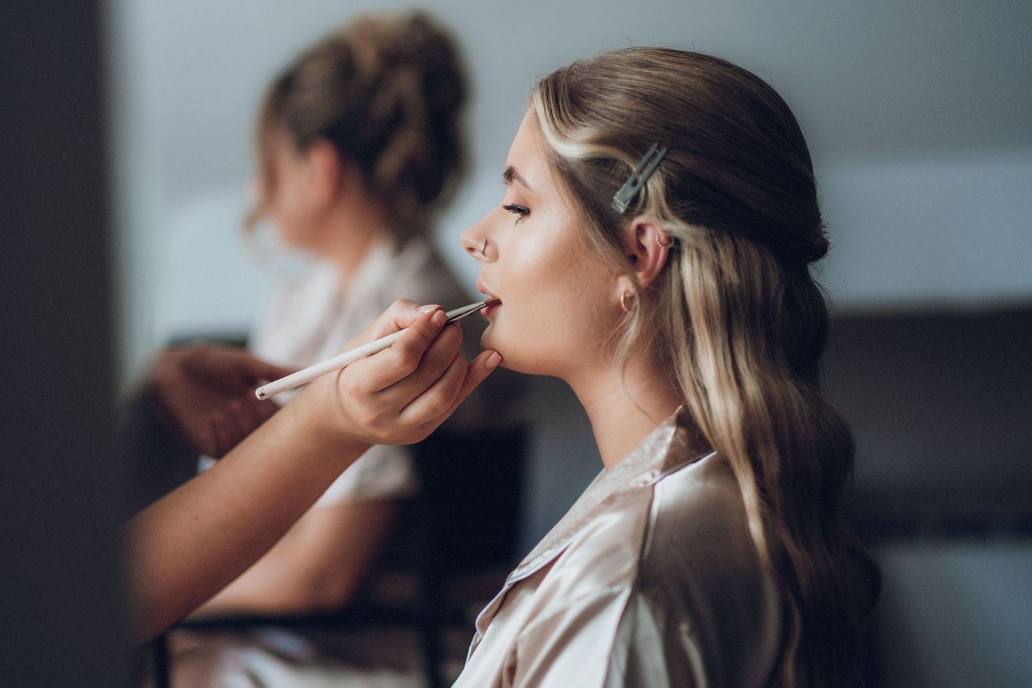 Close-up shots of wedding day makeup application in natural light.