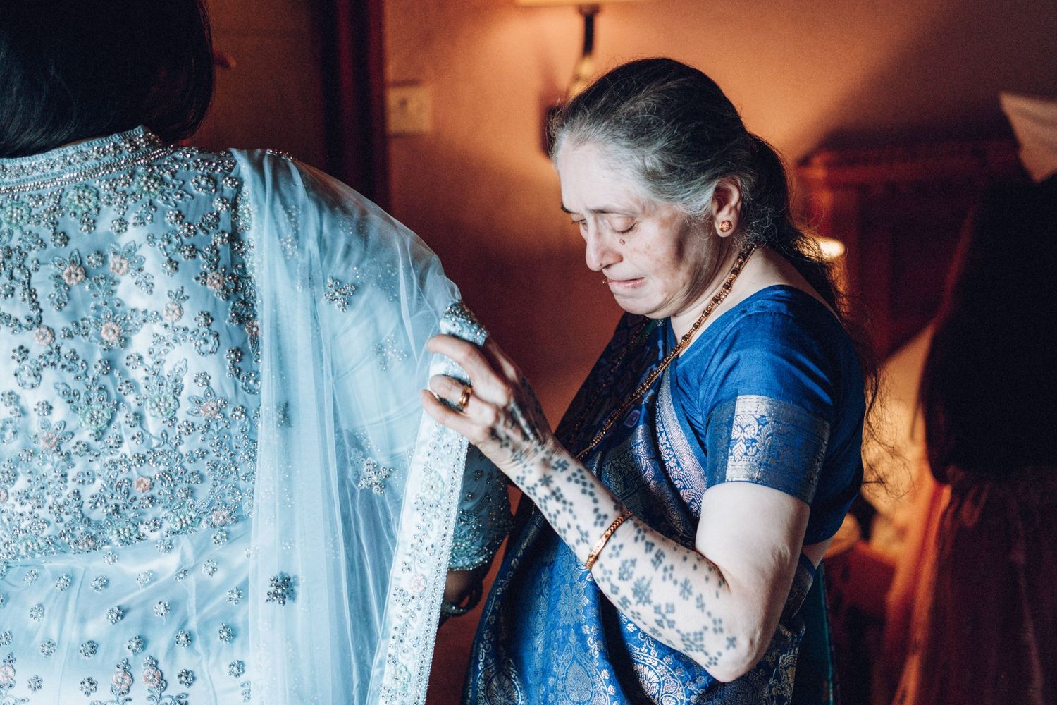 Wedding preparation scene with blue lighting and delicate details.