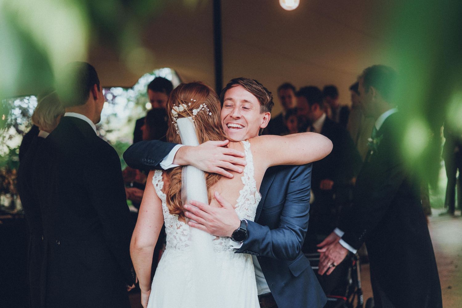 Wedding celebration inside venue with ambient lighting and festive atmosphere.