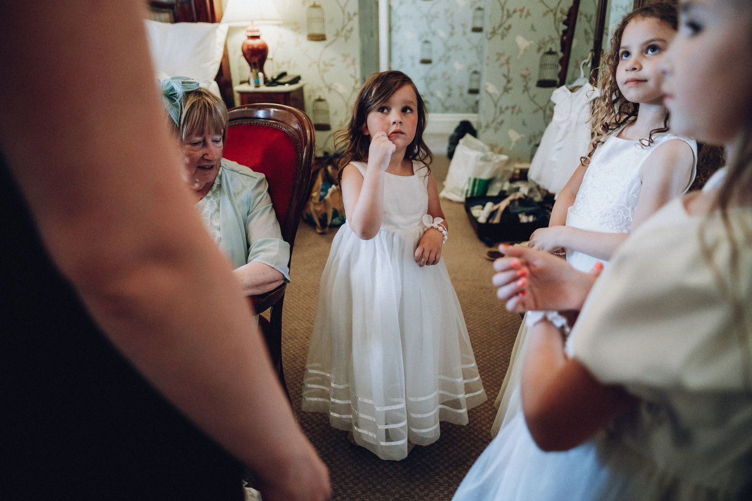 Wedding guests gathered in an indoor venue with vintage-style decor.