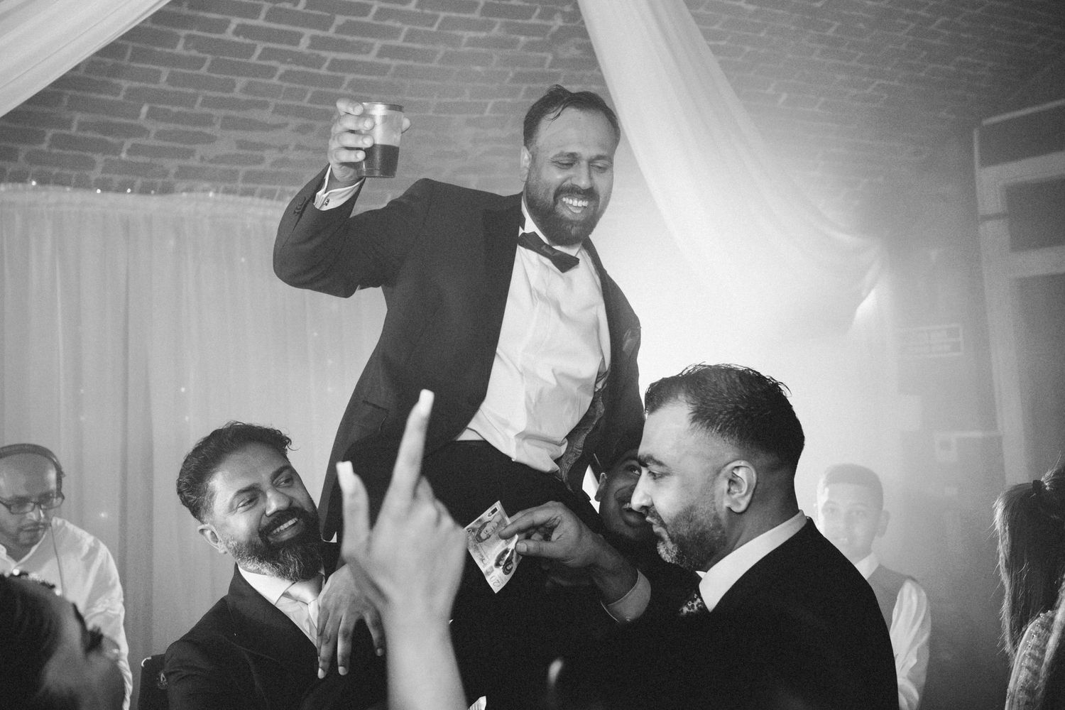 Black and white photos of lively wedding reception dancing and celebrations.