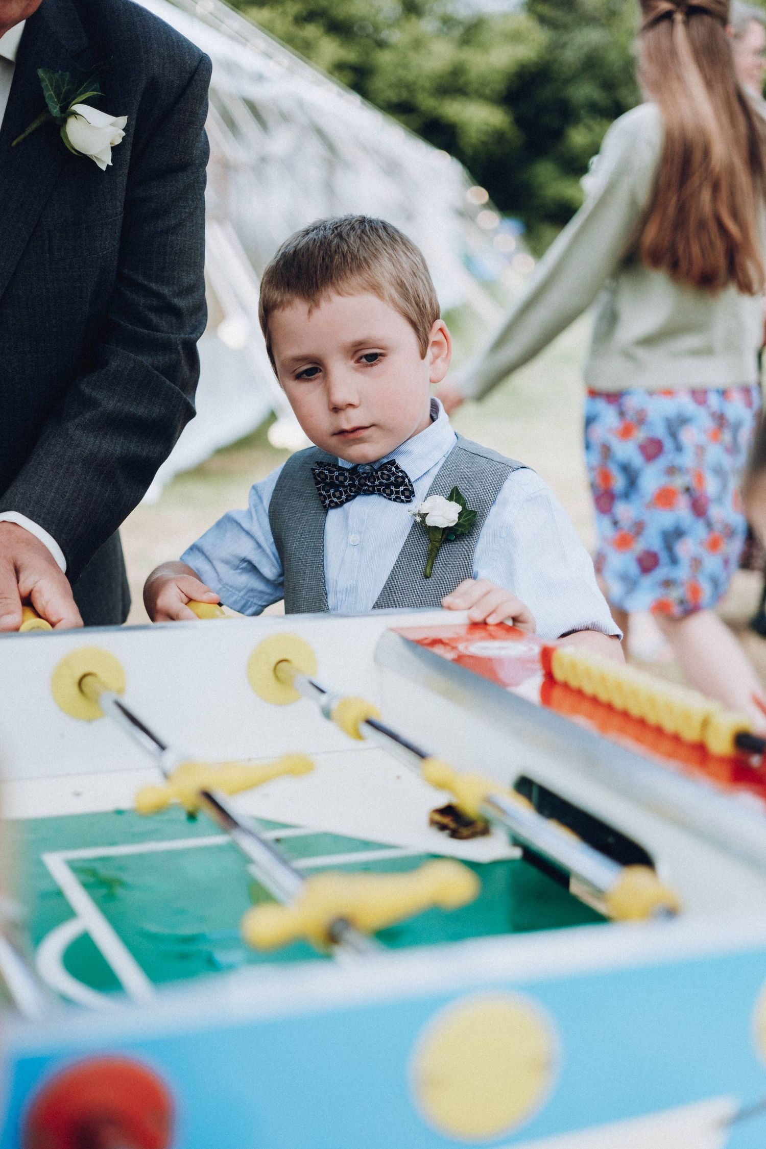 Children playing table football at an outdoor wedding reception.