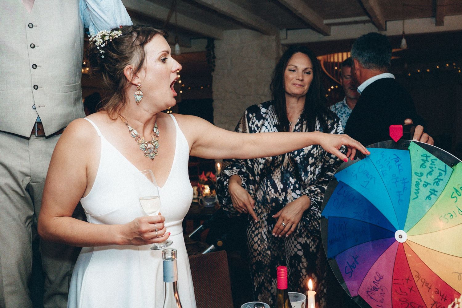 Lively dance party scene with colorful rainbow umbrellas and string lights decorating the ceiling.