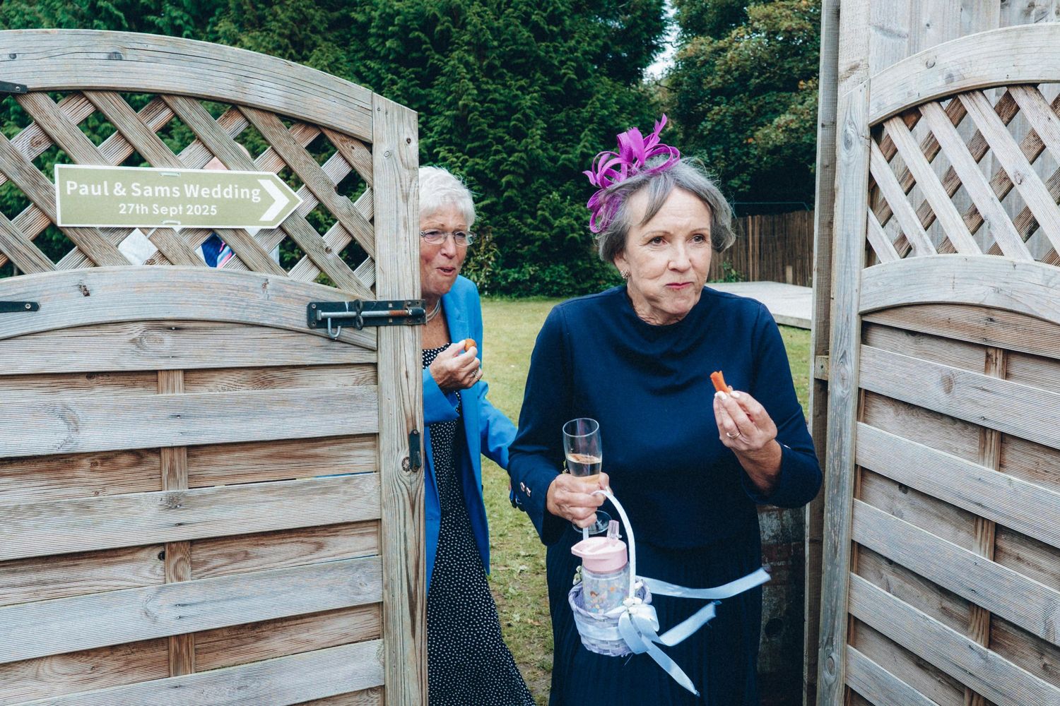 A rustic wooden fence with decorative elements at an outdoor event venue.