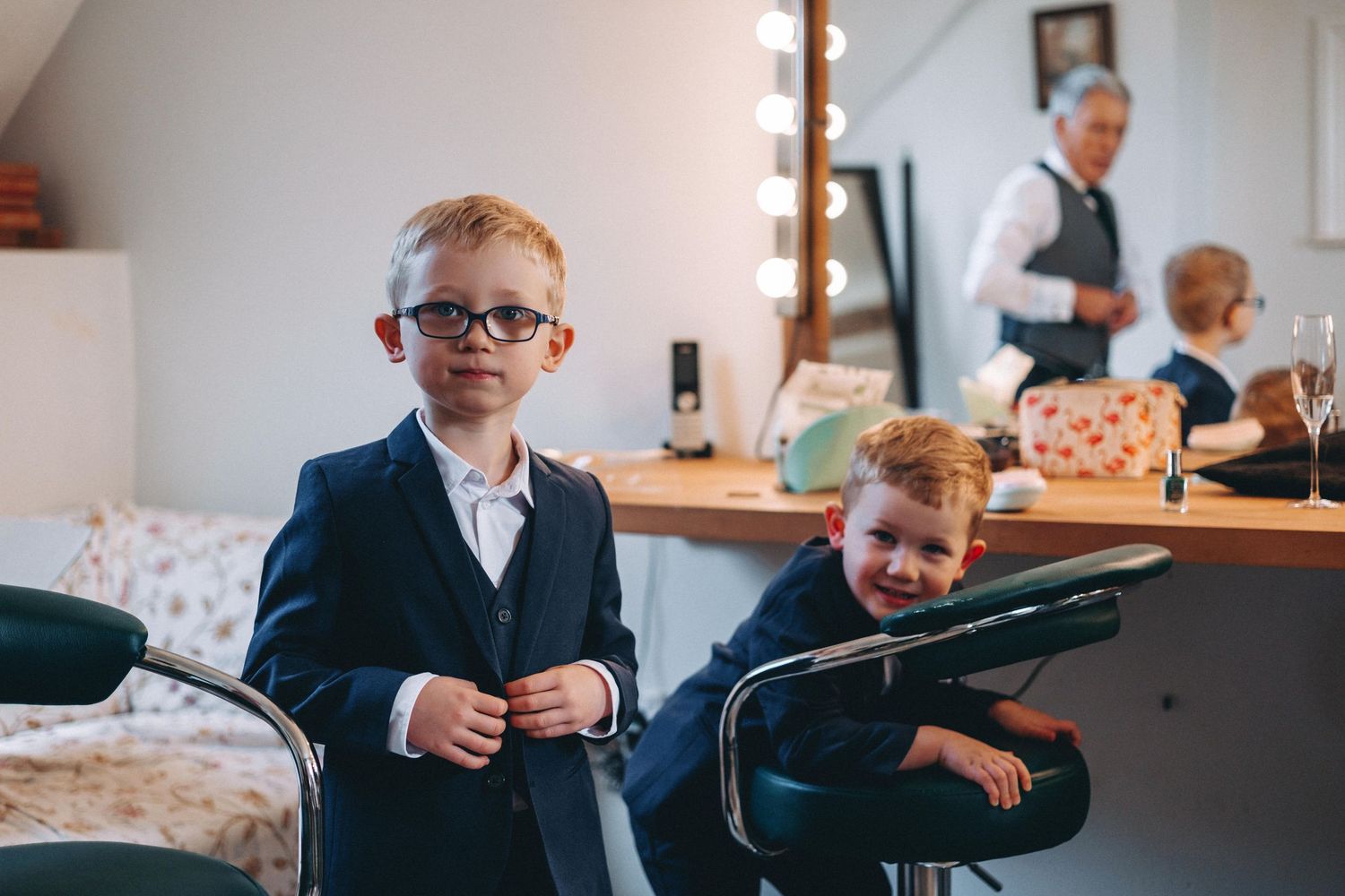Wedding party preparations in a bright indoor setting with classic furnishings.