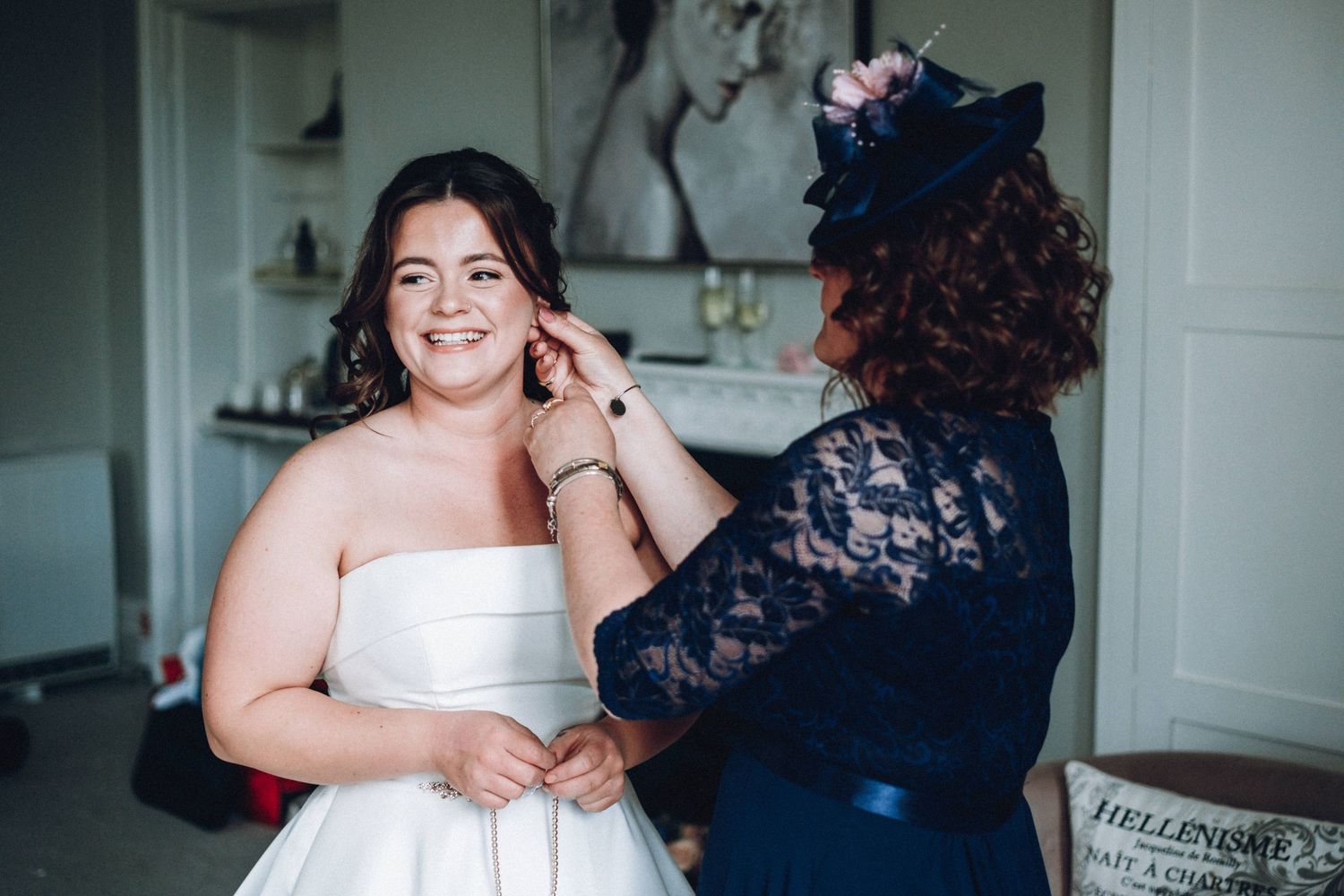 Wedding preparations showing bride in white dress with bridesmaids in pink dresses.