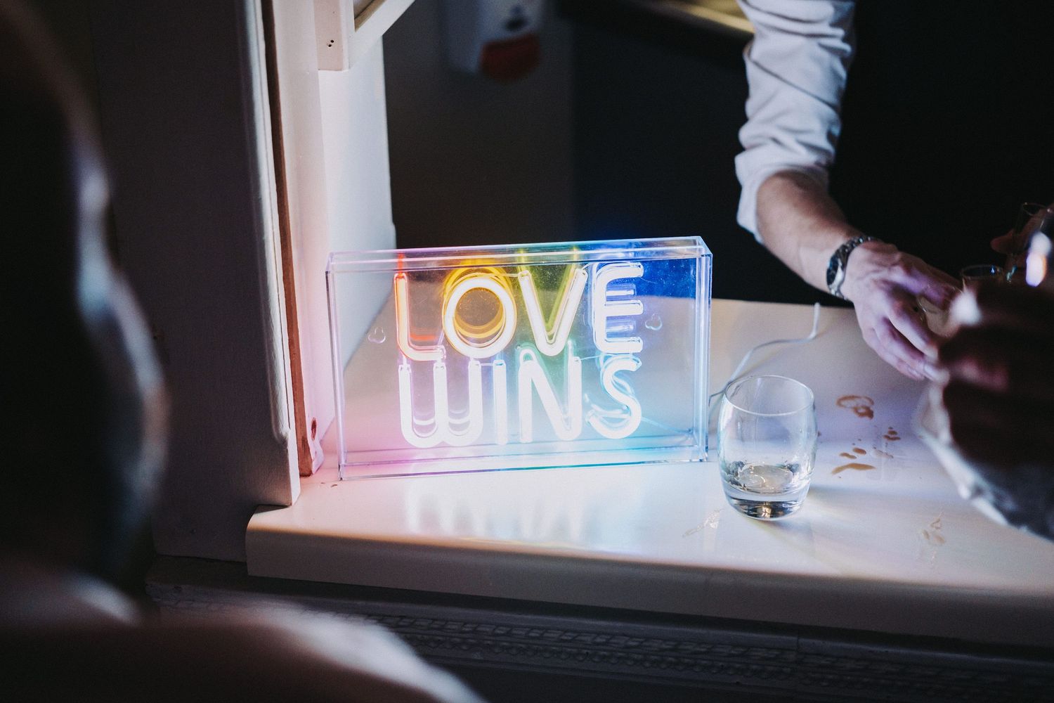 Illuminated neon signs glowing in a dark room creating ambient lighting.