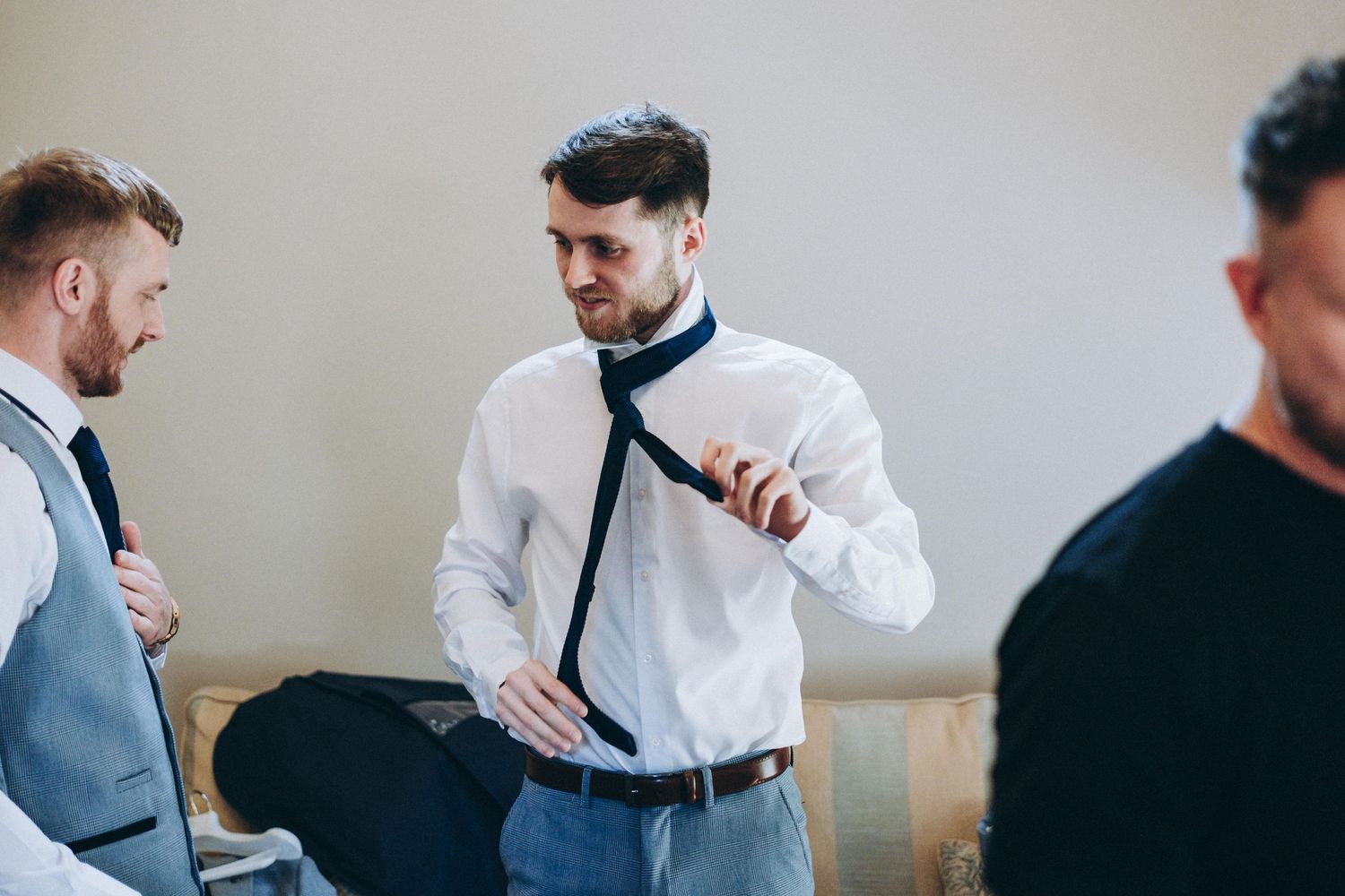 People in formal attire having a conversation during what appears to be a pre-event gathering.