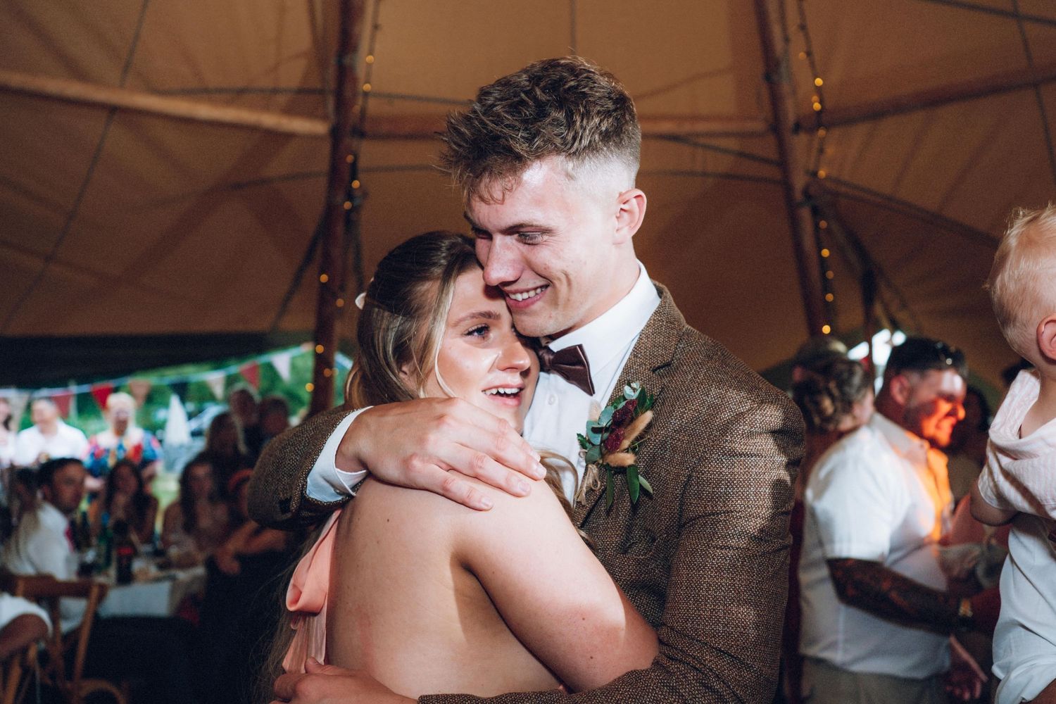 Couples dance together during romantic moments at evening wedding reception.