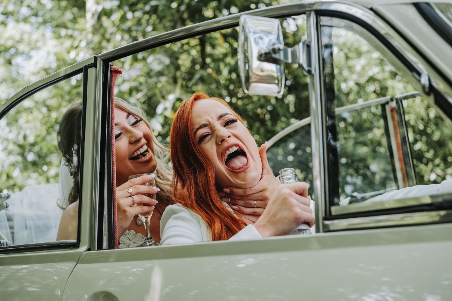 Joyful moments captured through a vintage car window on a sunny day.