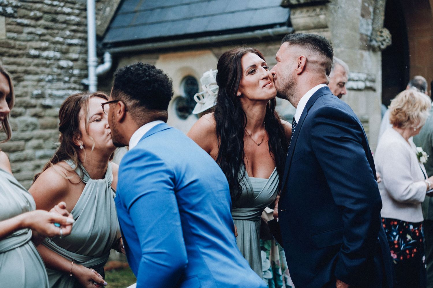 Wedding guests dancing and celebrating at an outdoor evening reception.