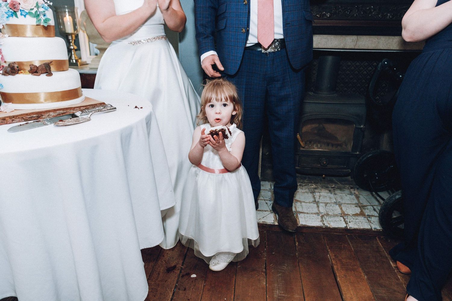 Wedding reception party with guests enjoying cake and refreshments.