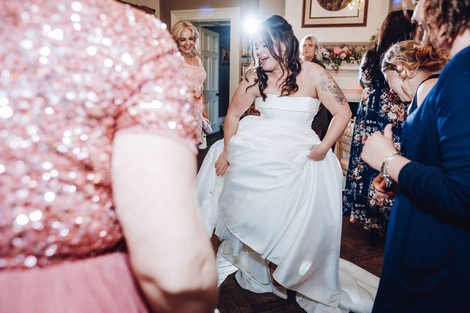 Wedding celebration with rose gold sparkly backdrop and festive atmosphere.
