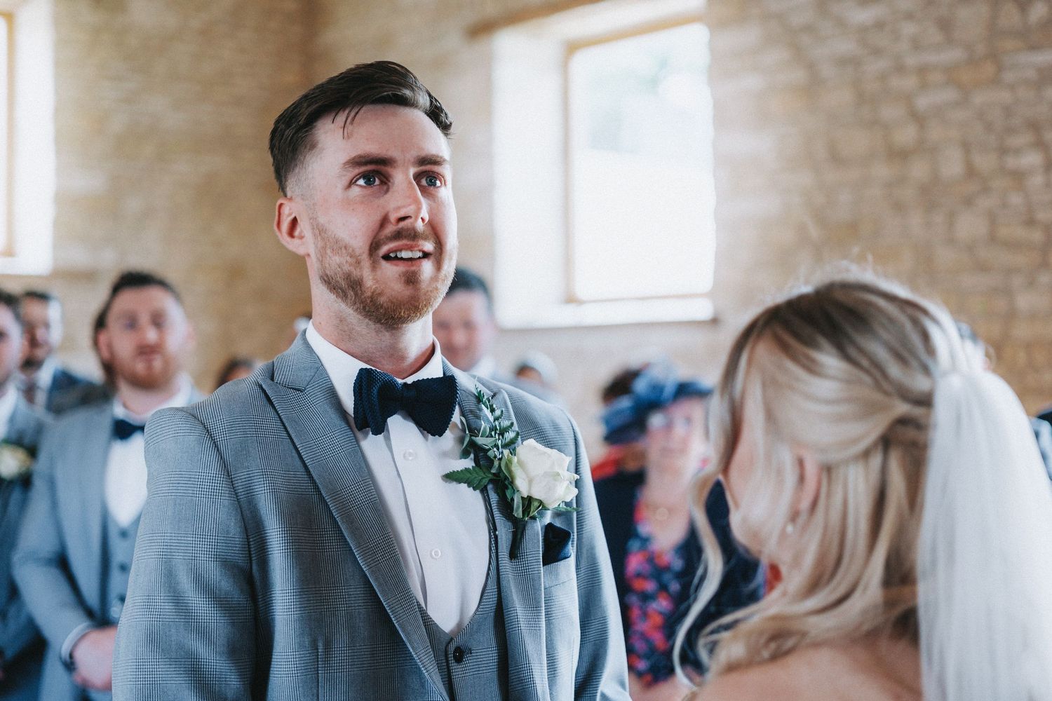 Wedding ceremony at a rustic stone venue with guests gathered to celebrate the special occasion.