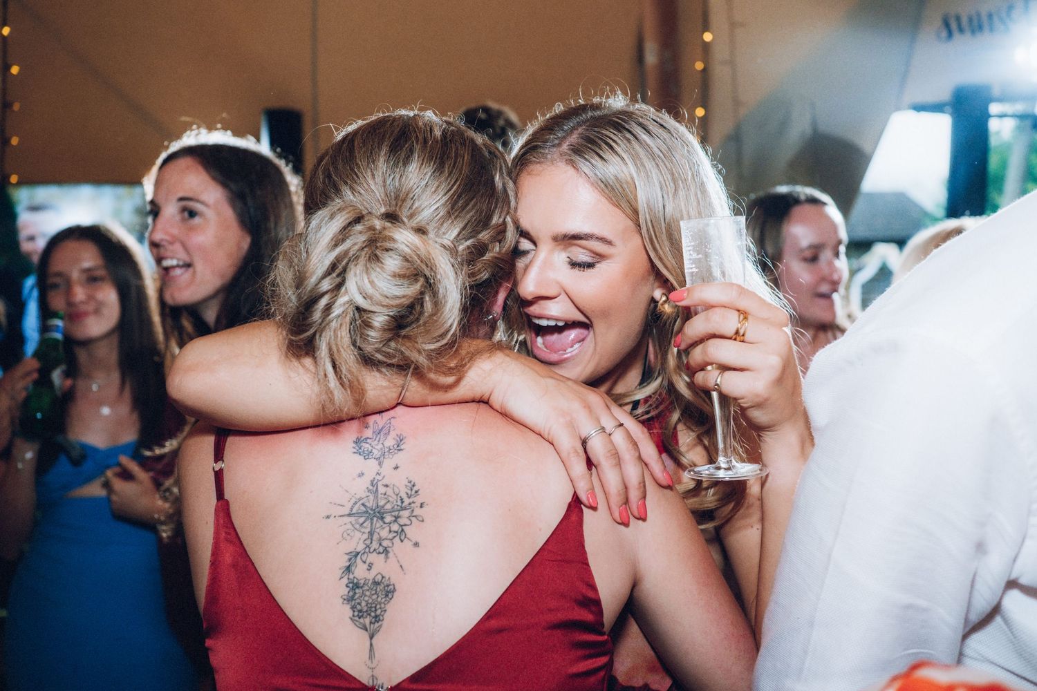 Wedding party guests enjoying themselves on a packed dance floor.
