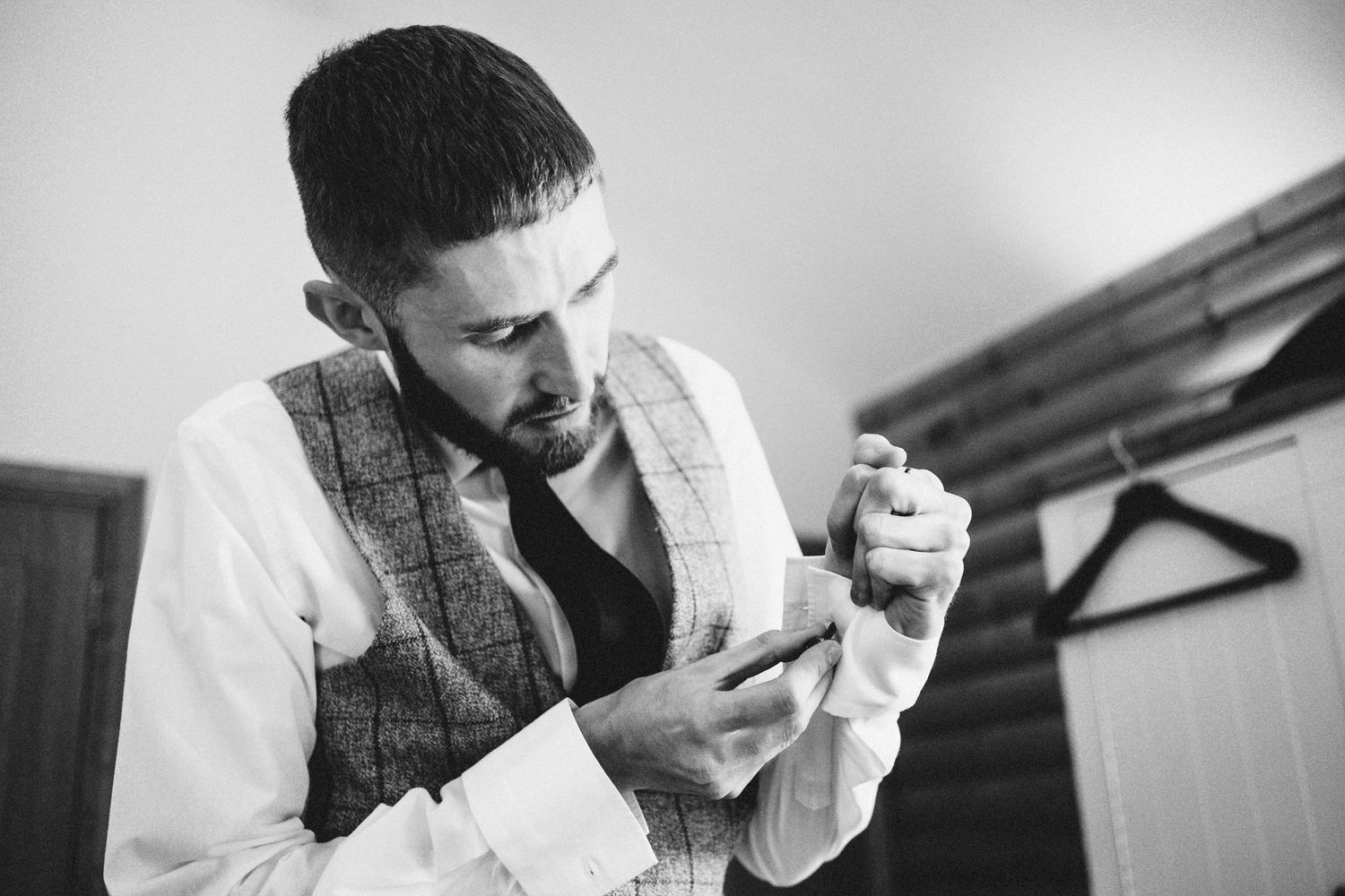 Black and white image of wedding preparations with focus on reading materials.
