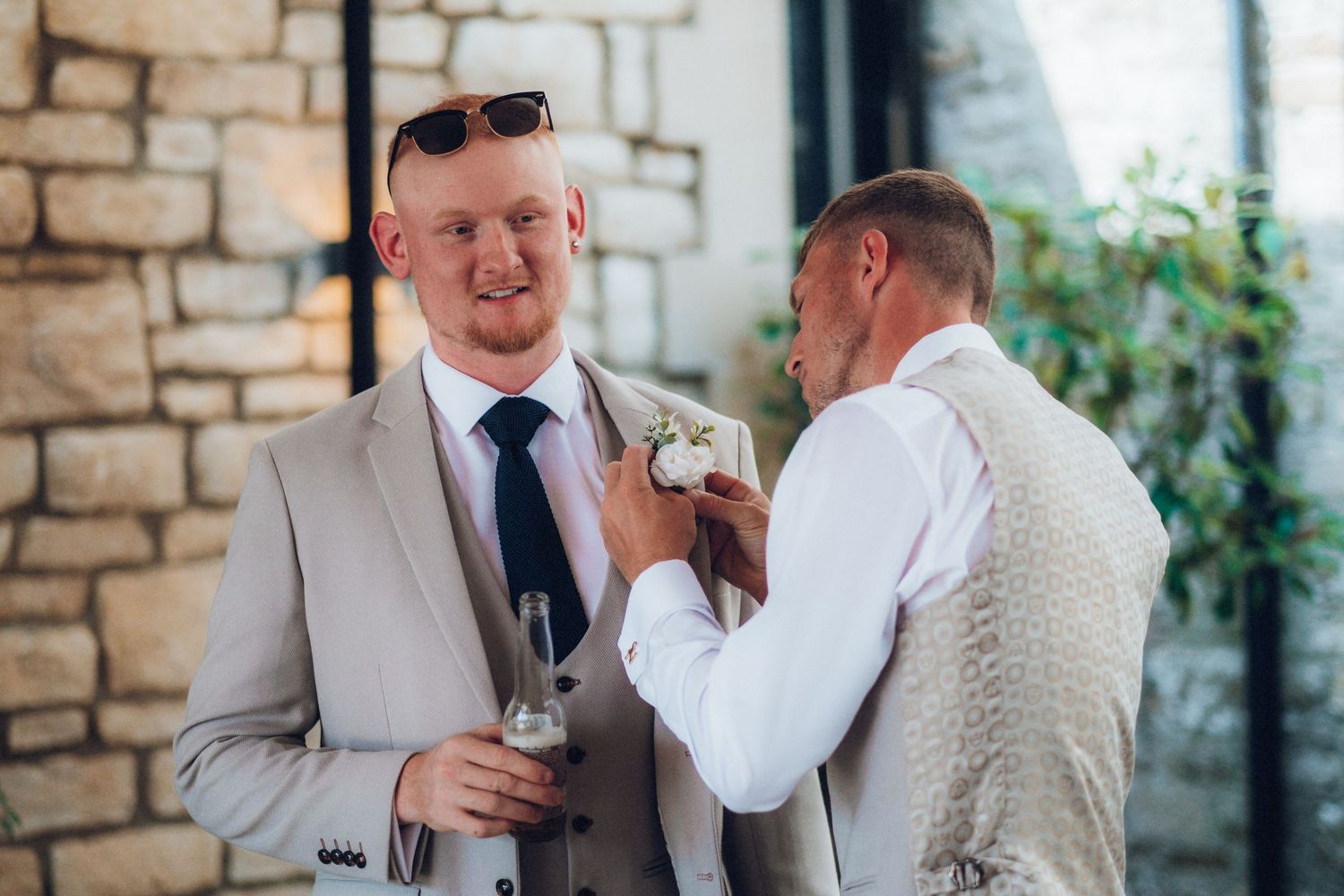 Emotional moments shared between wedding party members in a stone-walled venue.