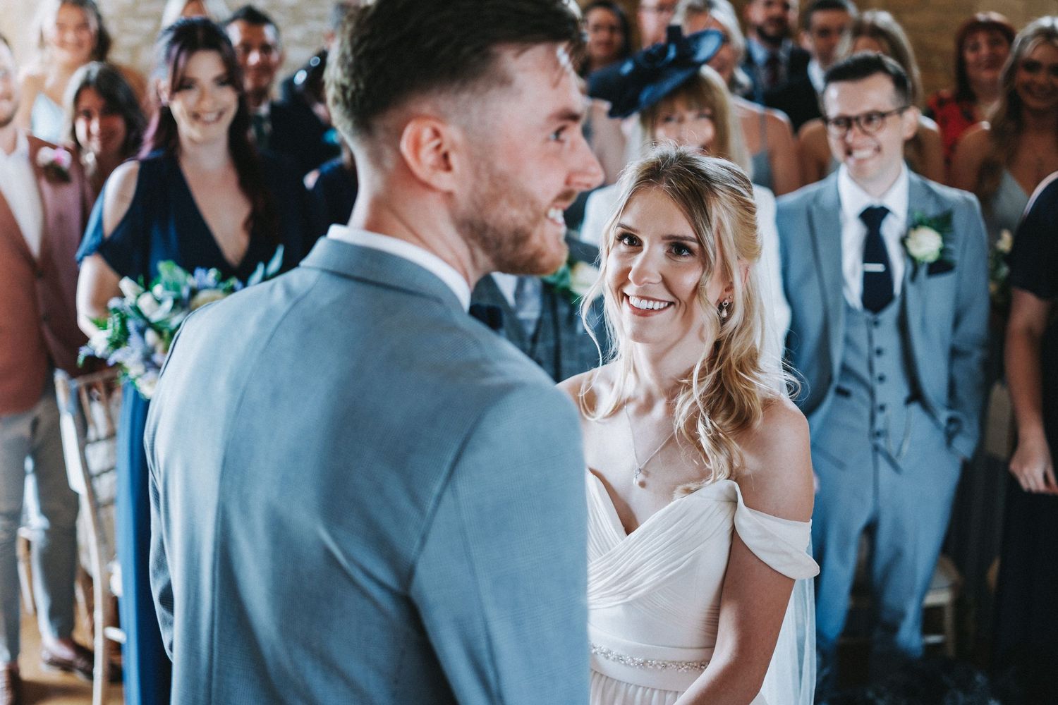 A couple shares a special moment at the altar during their wedding ceremony, with guests looking on in the background.