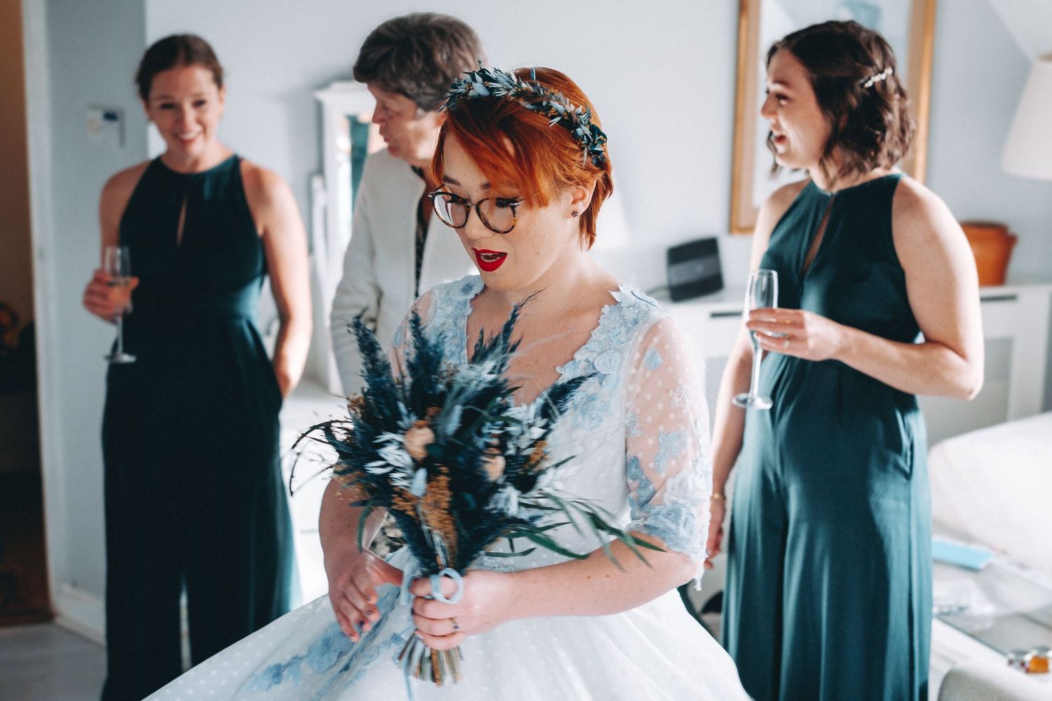 Wedding party members getting ready in coordinated blue and gray outfits.