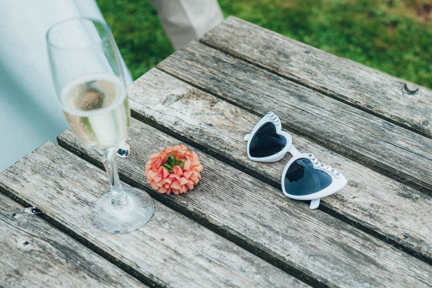 Close-up shots of formal shoes and decorative elements on weathered wooden planks.