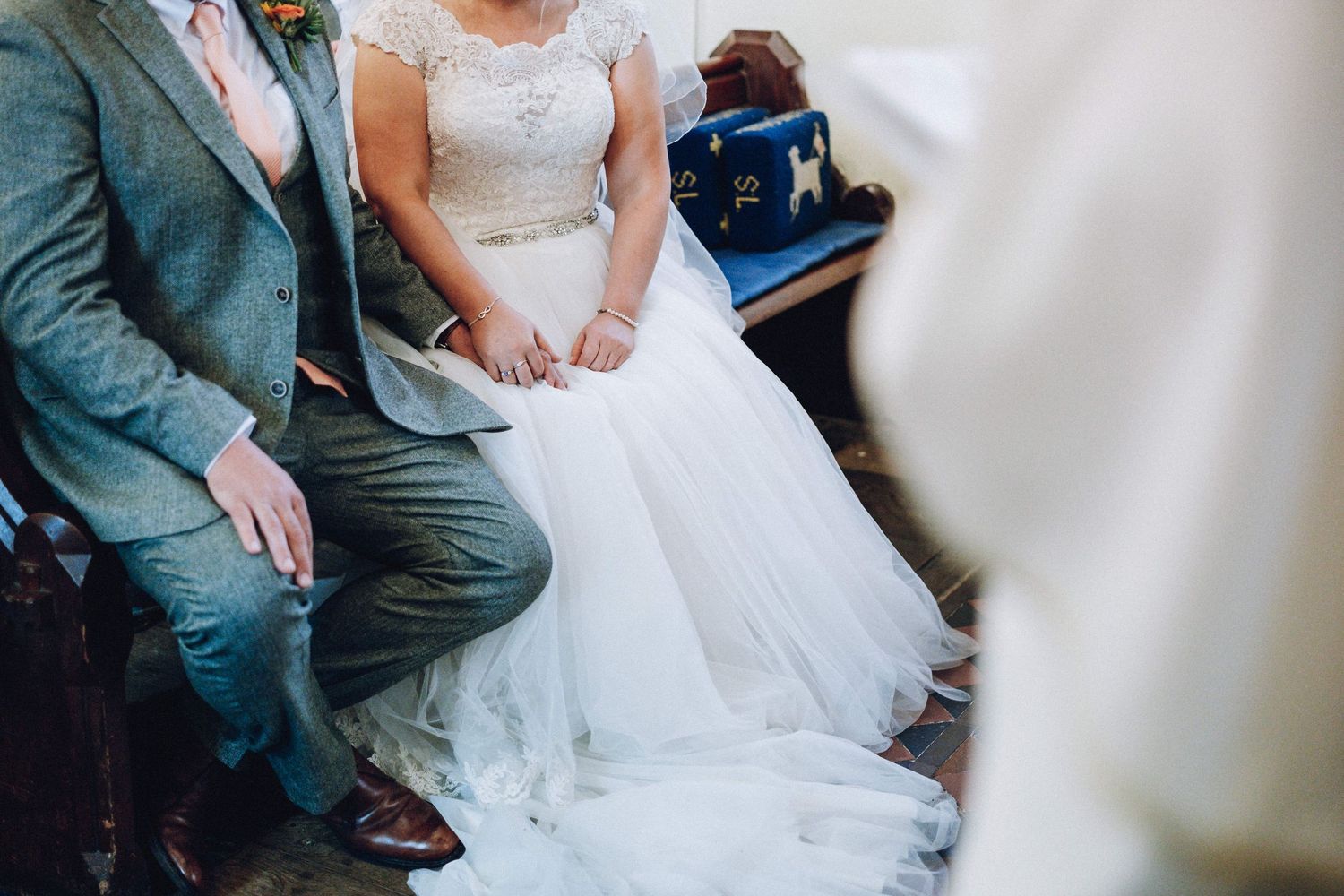 Elegant wedding ceremony moments captured in a bright indoor venue with white decor.