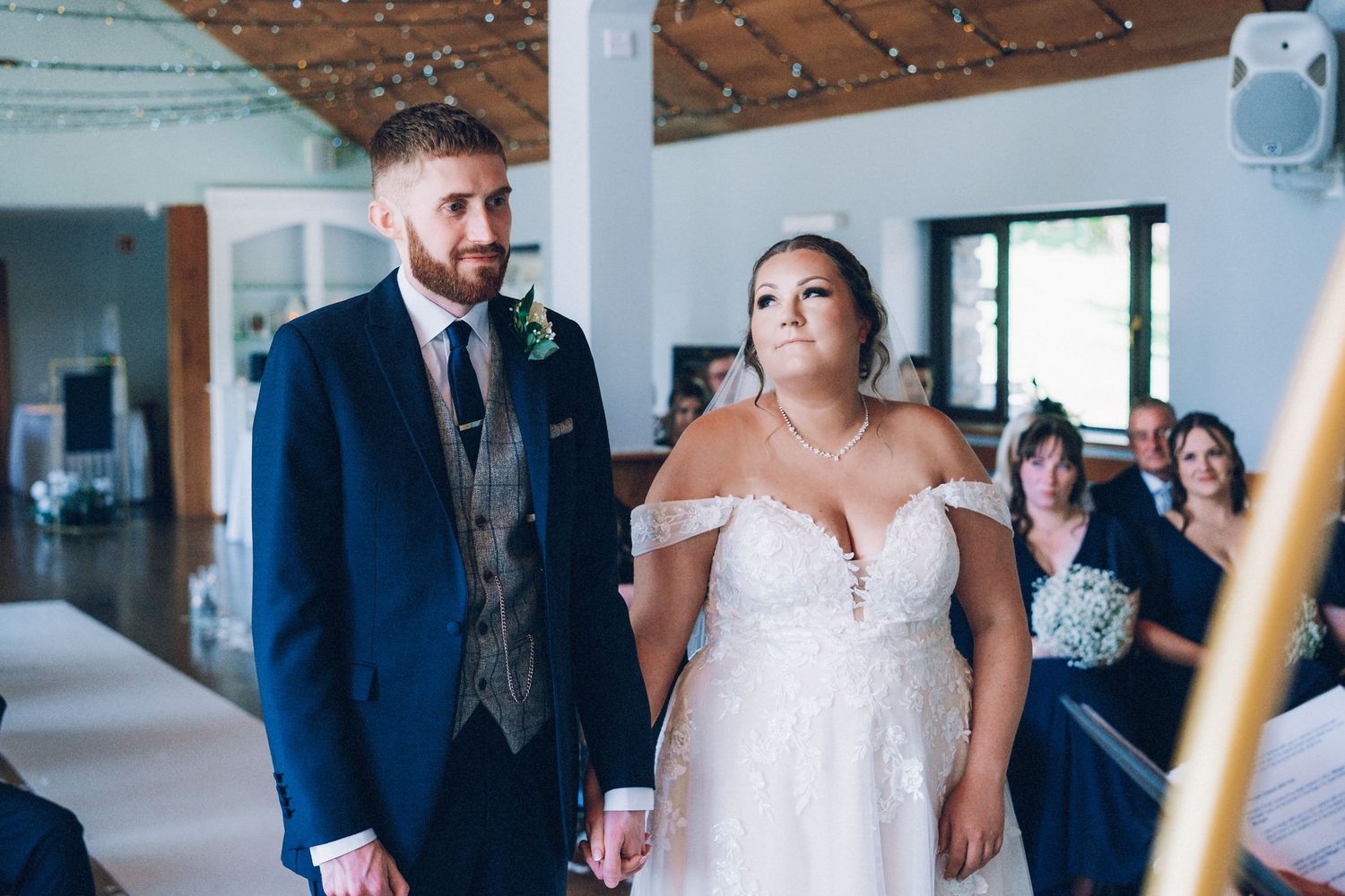 Modern wedding venue interior with wooden details and natural lighting.