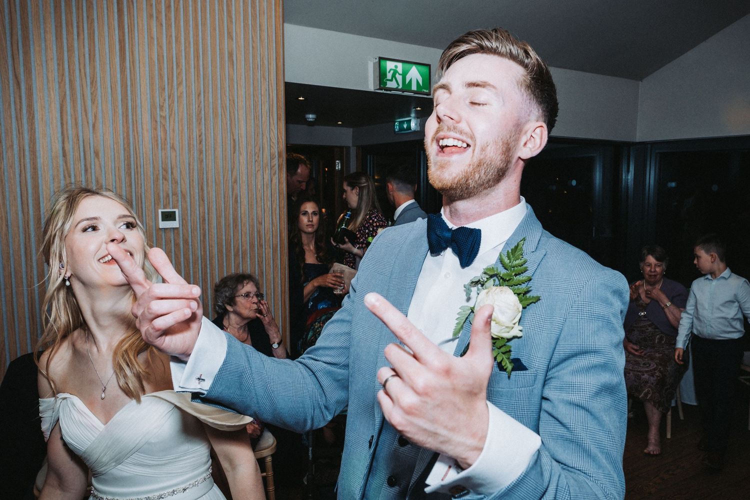 A party moment on the dance floor at a wedding reception with guests celebrating in formal attire.