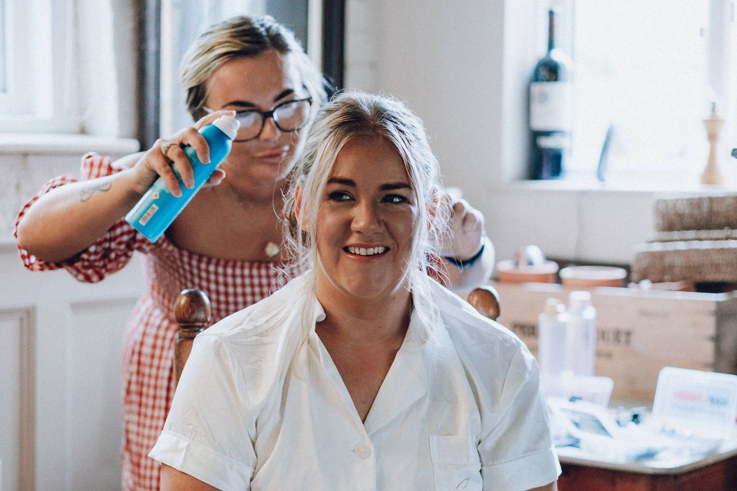 Hair styling session in progress with styling products and tools.