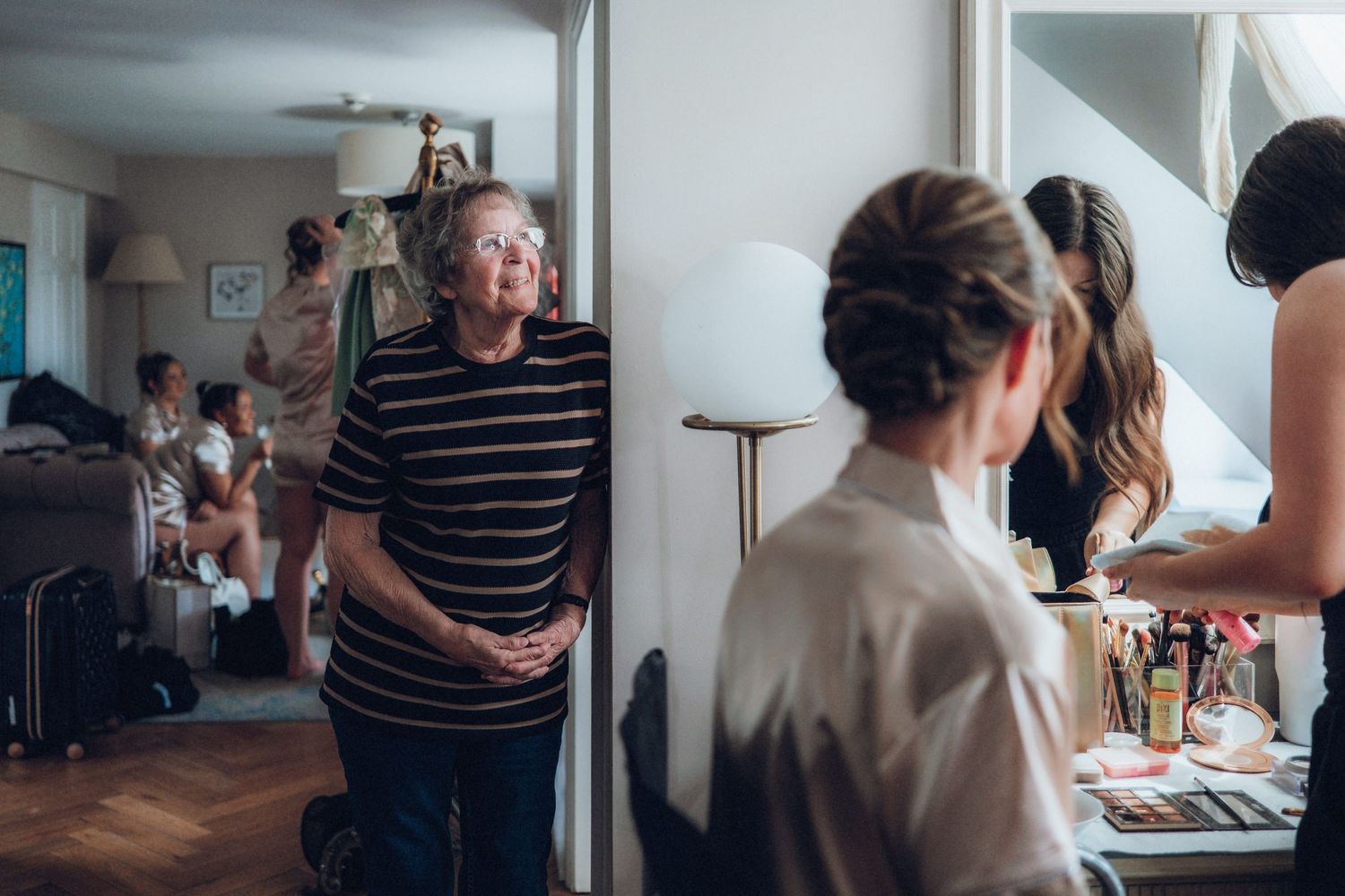 Wedding party members gather in a bright indoor space during pre-ceremony preparations.