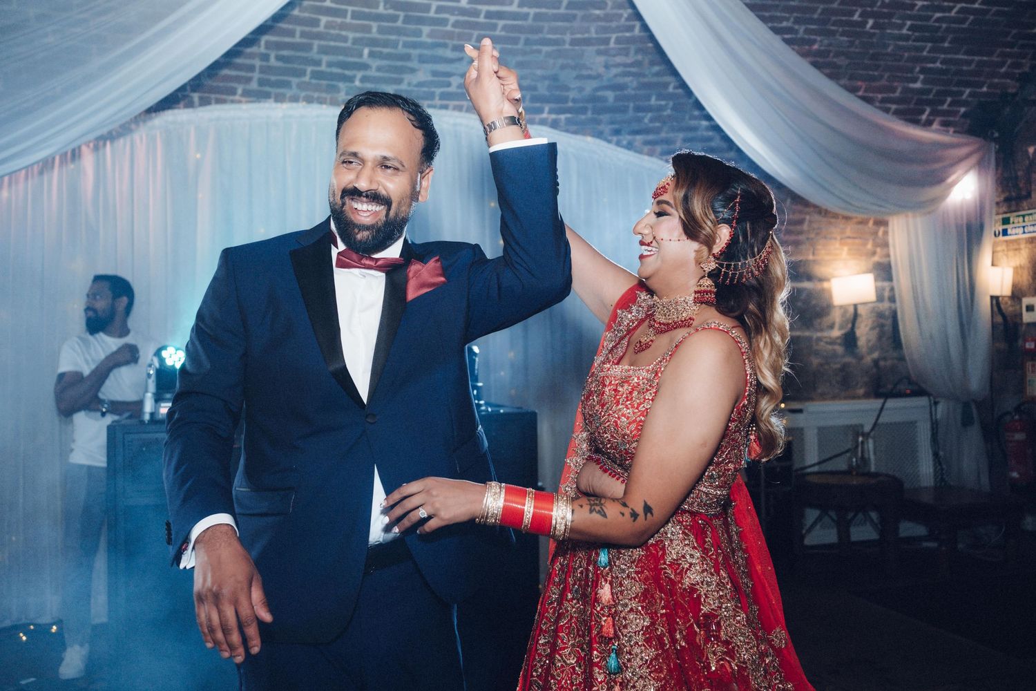 Wedding reception dance floor moments with elegant lighting and decor.