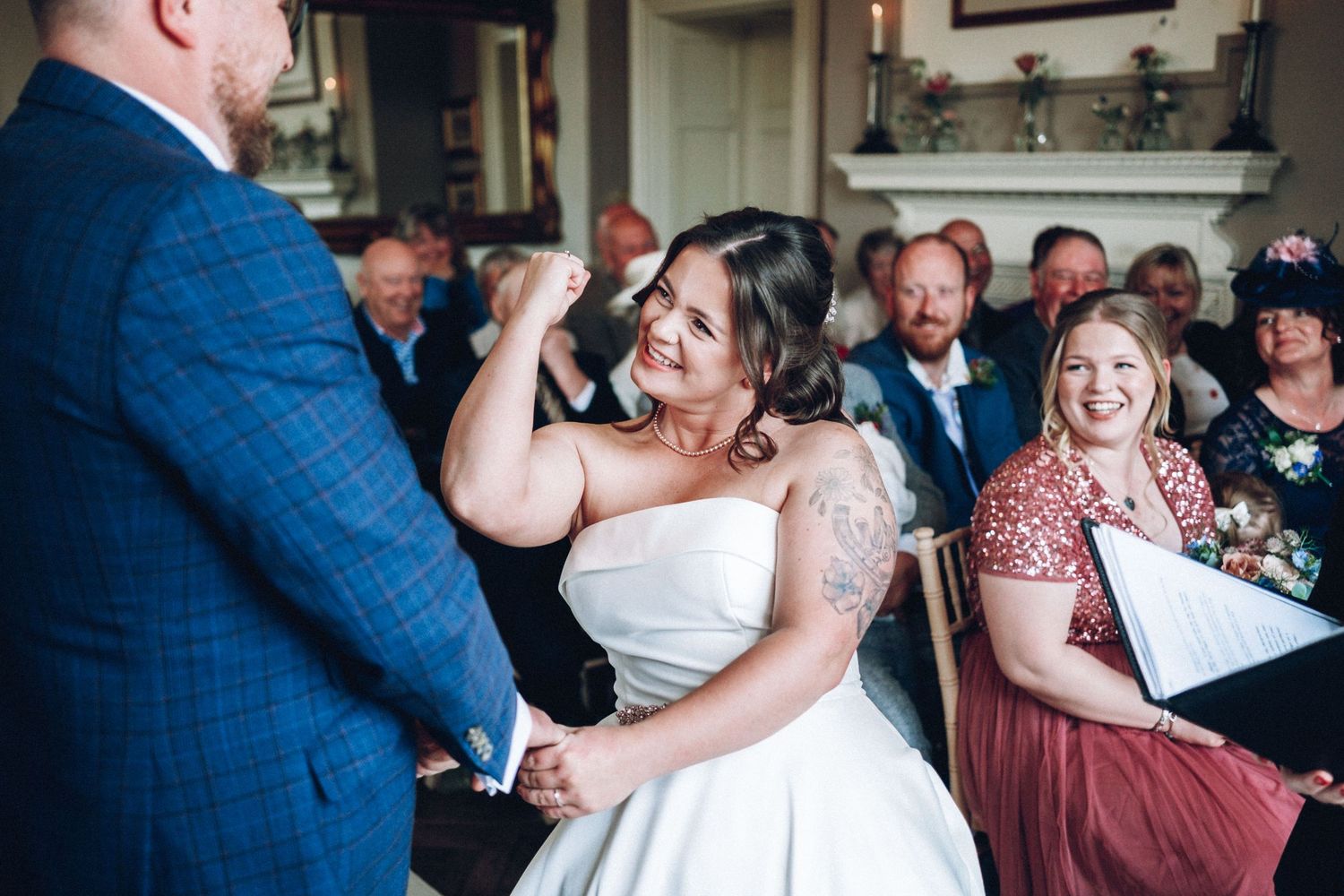 Wedding reception guests dancing and celebrating on a crowded dance floor.
