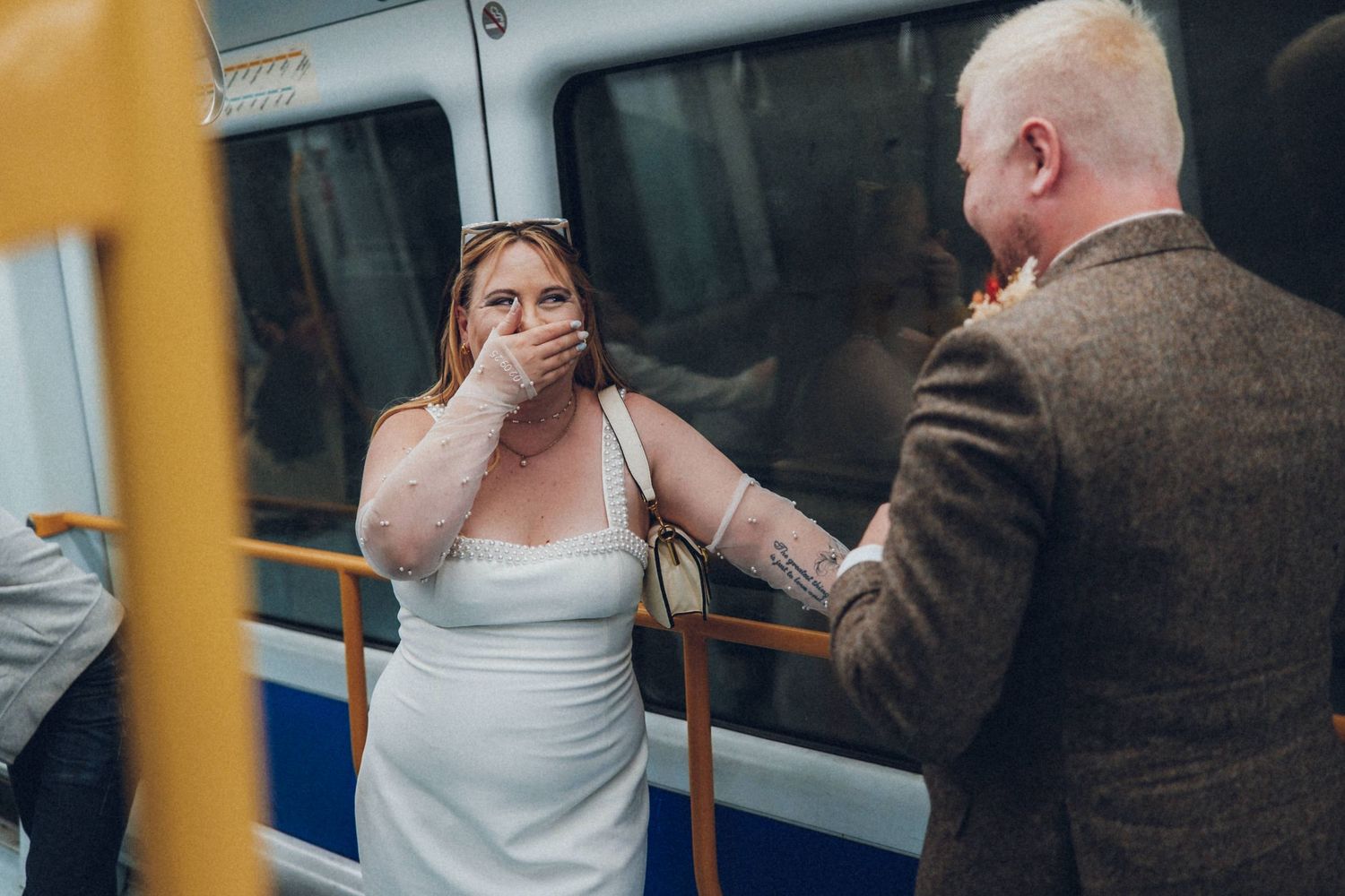 Candid moments captured inside a train car during wedding celebrations.