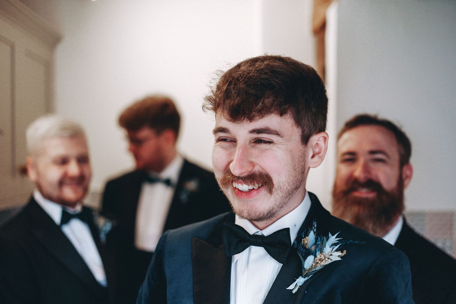 Wedding party members in formal attire sharing a candid moment.