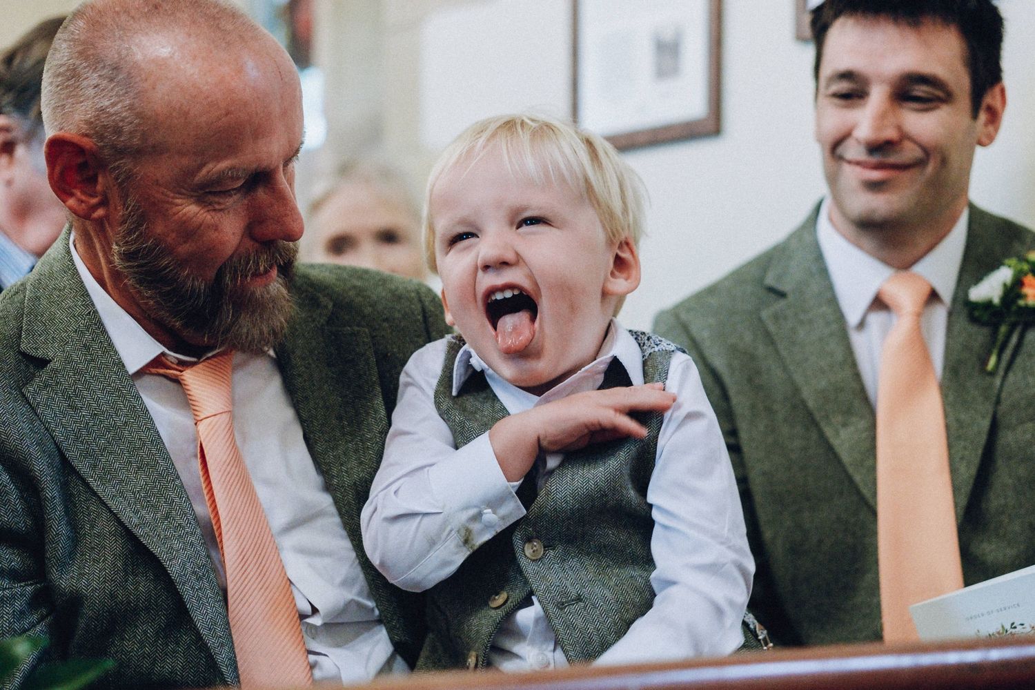 Candid reactions and laughter during wedding reception festivities.