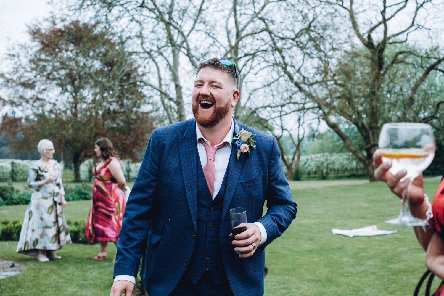 Wedding celebration in an outdoor garden setting with navy and pink color scheme.