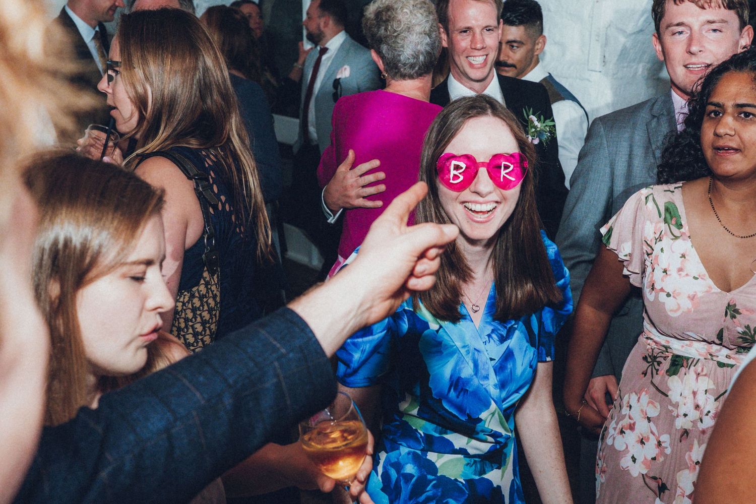 Wedding guests dancing and enjoying themselves at a lively reception party.