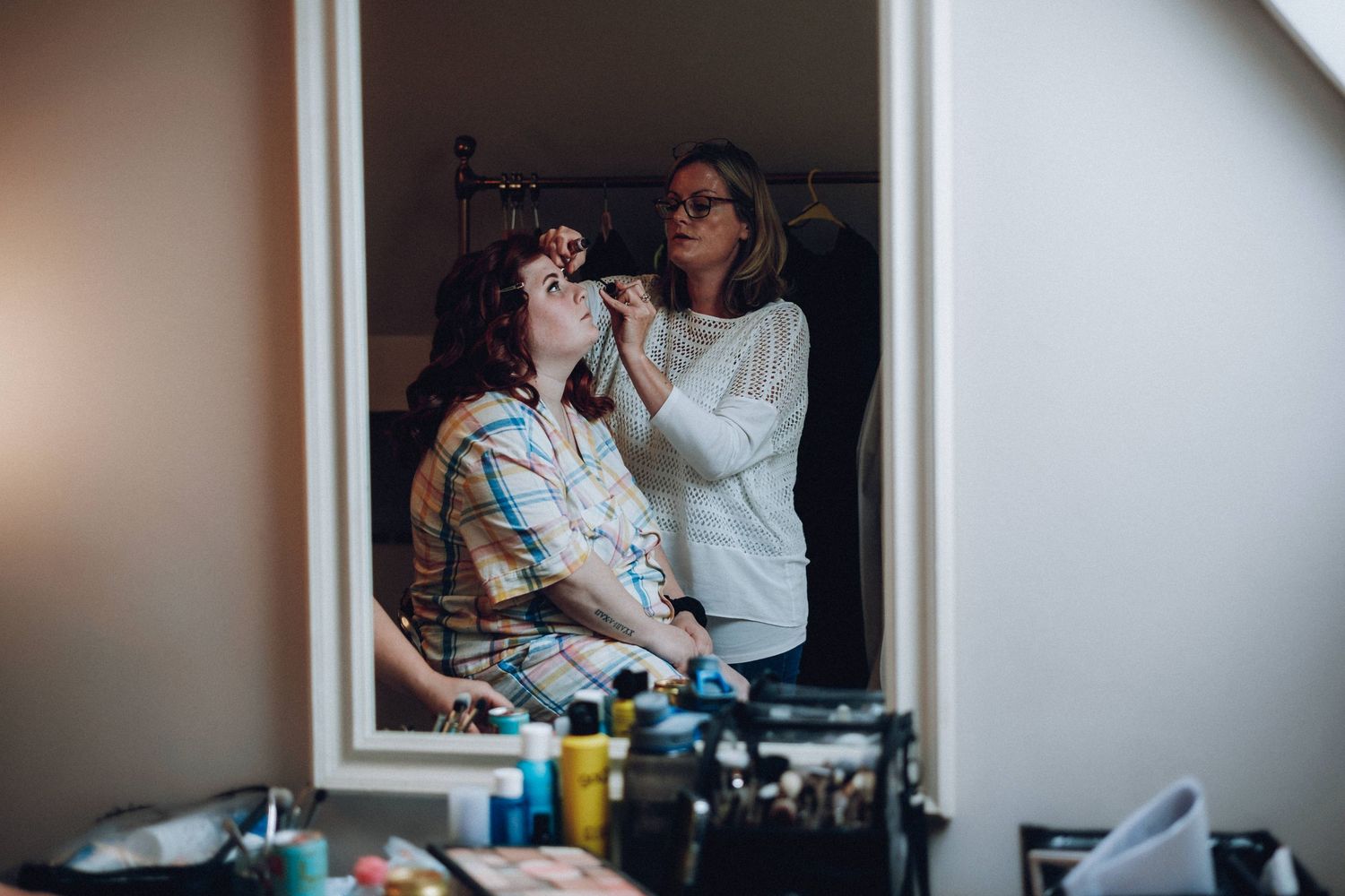 Getting ready moments captured in a bright room before the wedding ceremony.