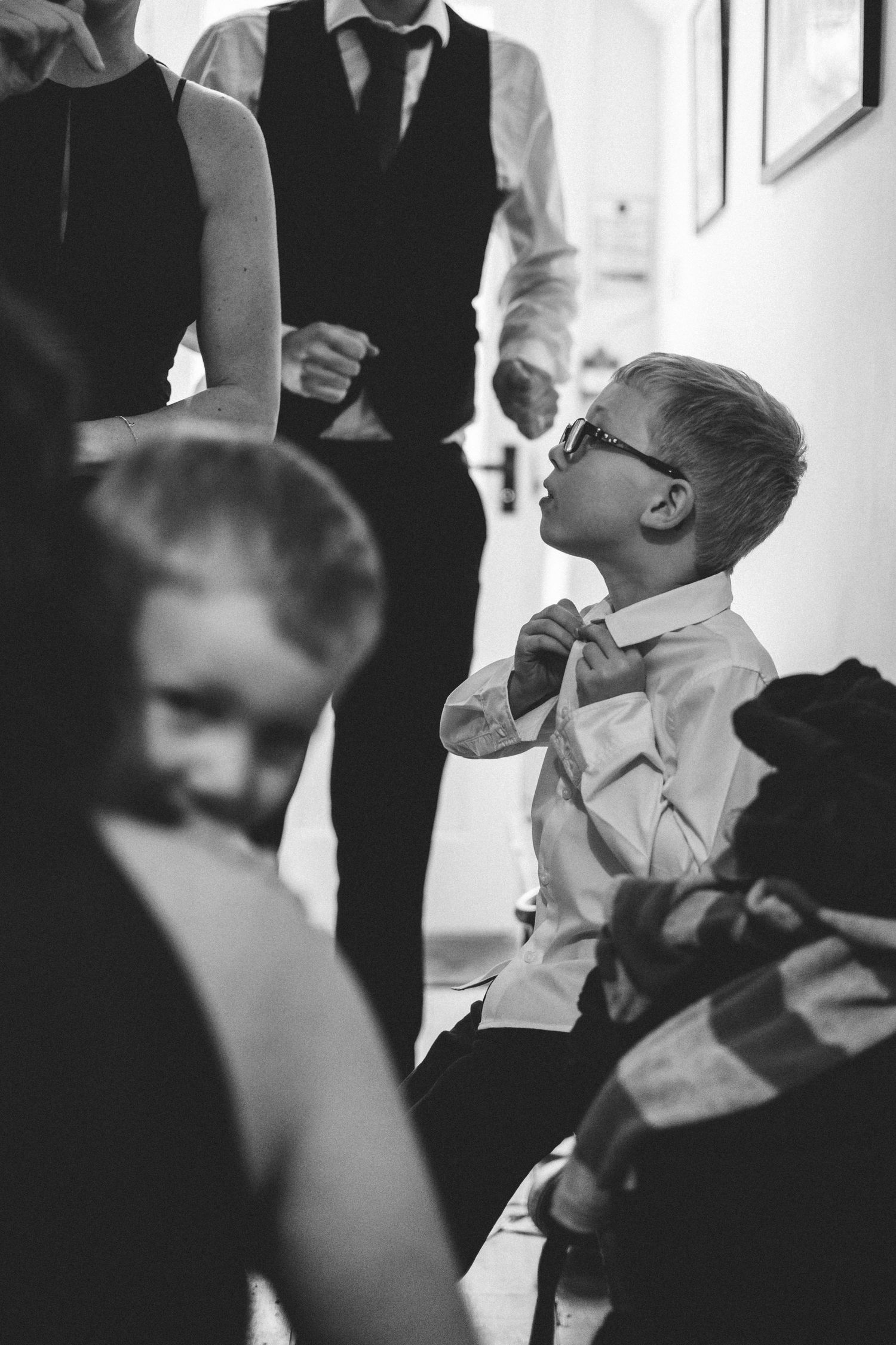 Getting ready in front of a mirror in formal attire before an event.