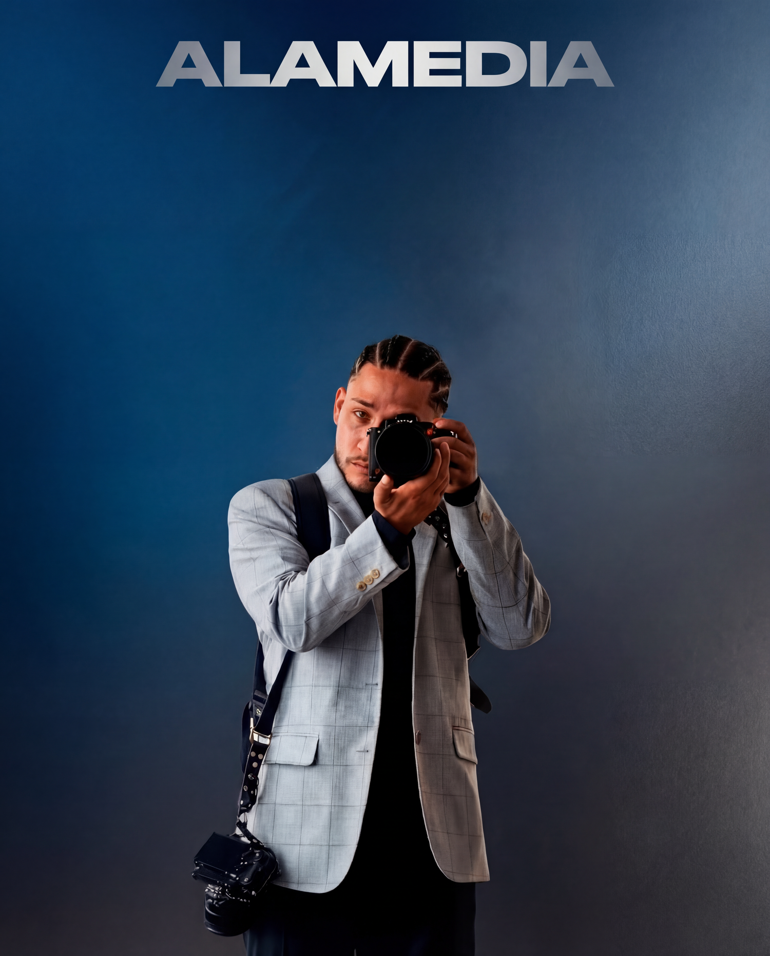 Professional photographer holding a camera in a dramatic blue-lit studio setting with ALAMEDIA branding overhead.