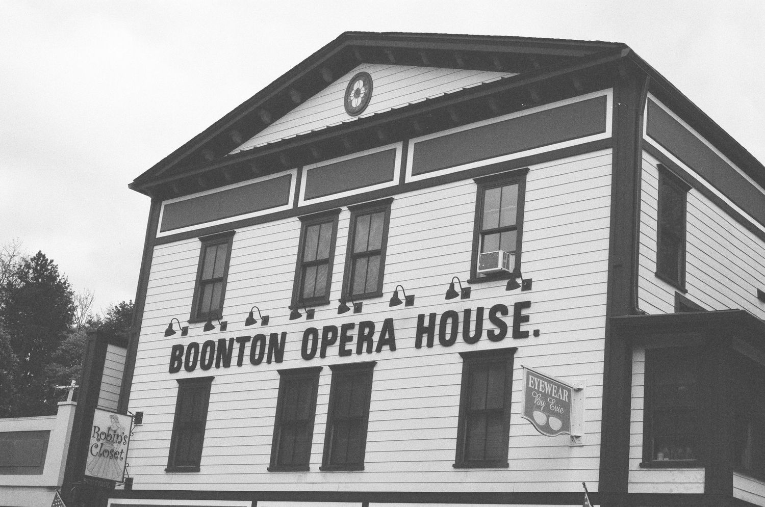 Historic white wooden Boonton Opera House building with classic Greek Revival architecture.