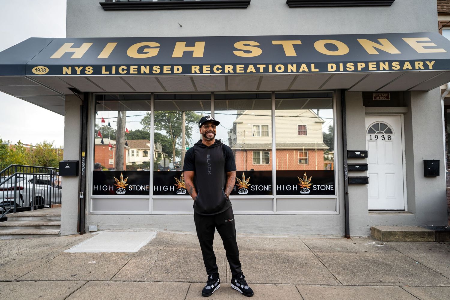 Man standing in front of High Stone NYS Licensed Recreational Dispensary storefront.