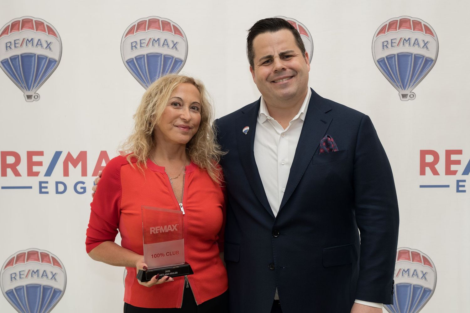 RE/MAX Edge realtor receives award alongside RE/MAX Edge broker at ceremony.