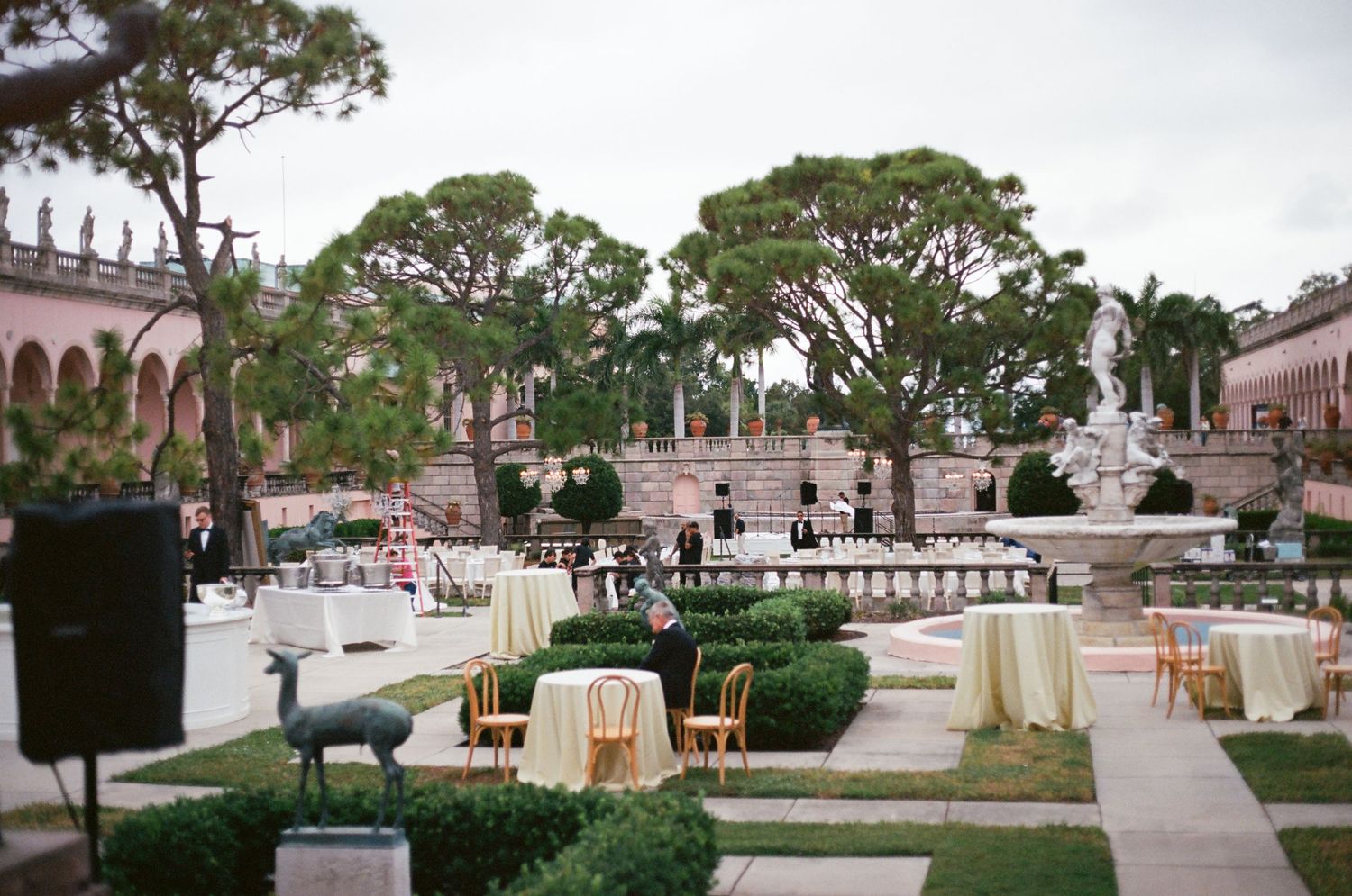 Elegant outdoor wedding reception venue at Ringling Museum with manicured gardens and fountain.