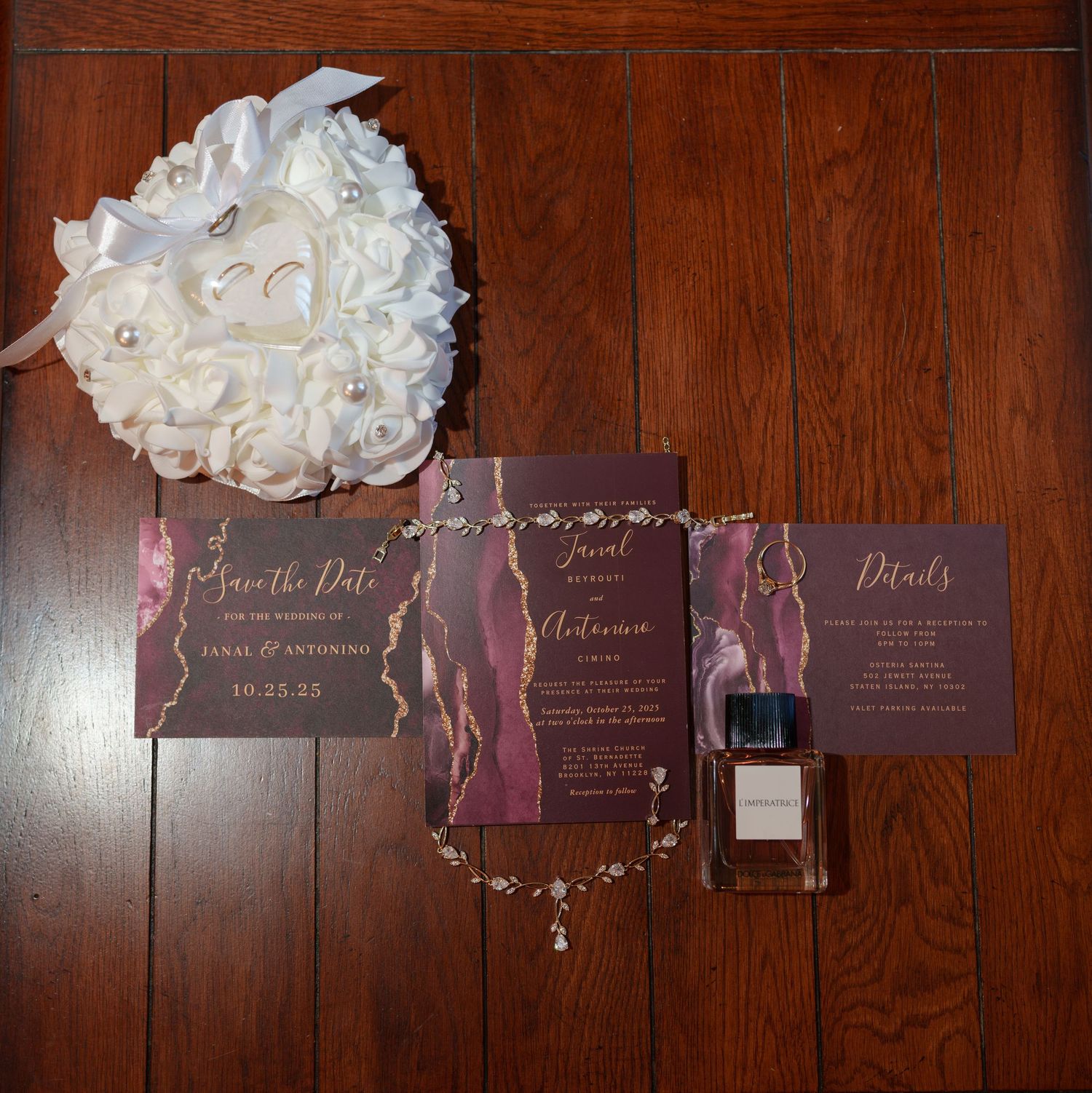 Wedding stationery flat lay featuring save the date cards, invitations, and white rose bouquet.