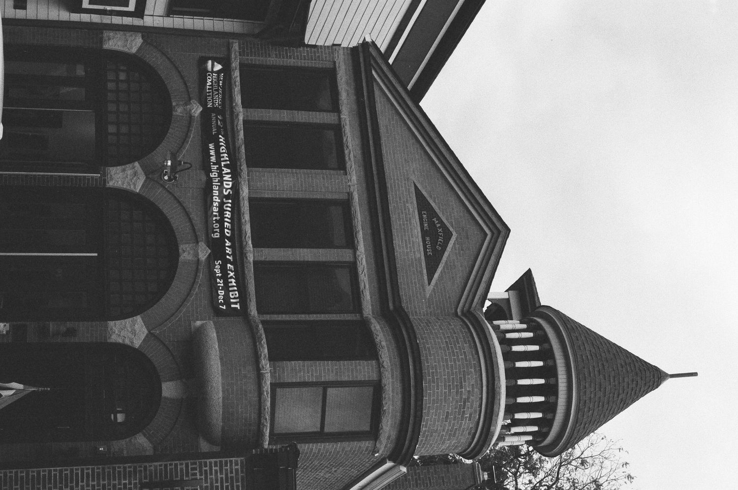 Black and white photo of a grand historic church building with a pointed spire and arched windows.