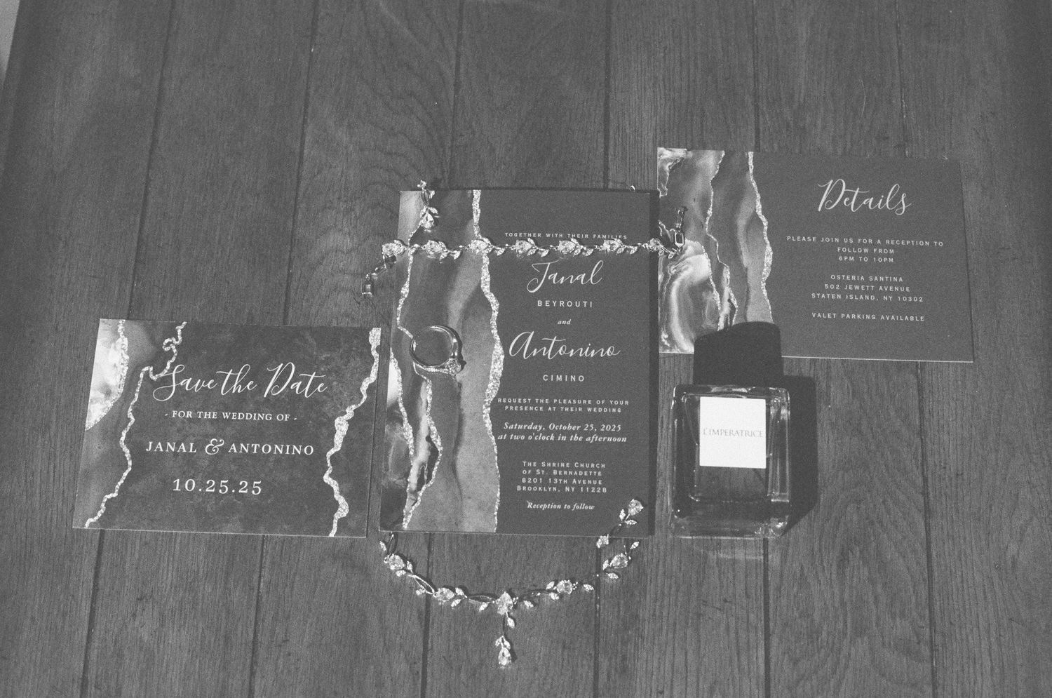 Black and white flat lay of elegant wedding invitation suite with save the date cards.