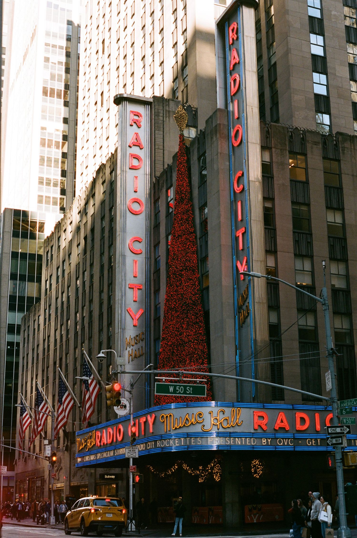 Radio City Music Hall marquee with red neon signs on 50th Street in Midtown Manhattan, NYC.