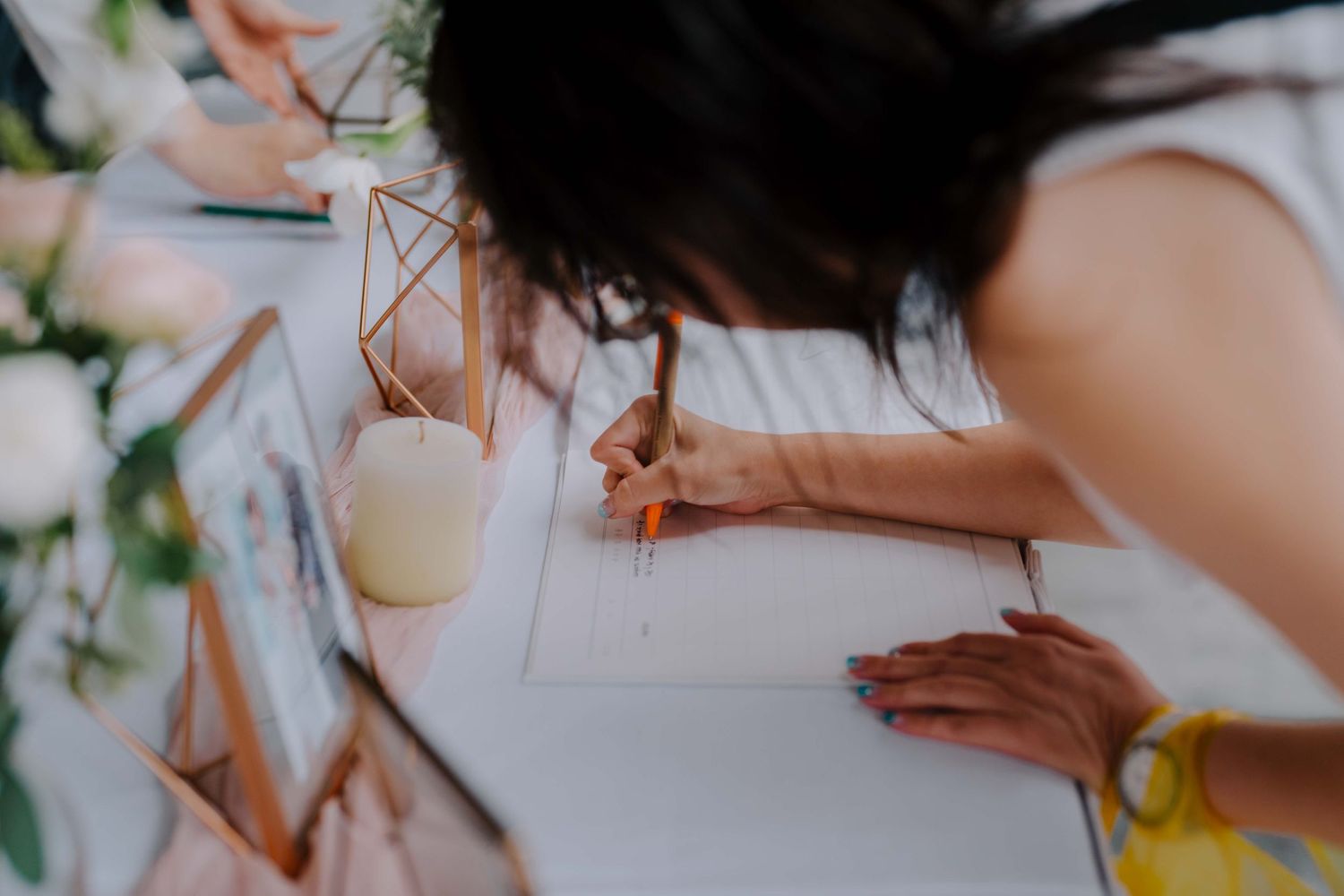 wedding guest writing on a guestbook